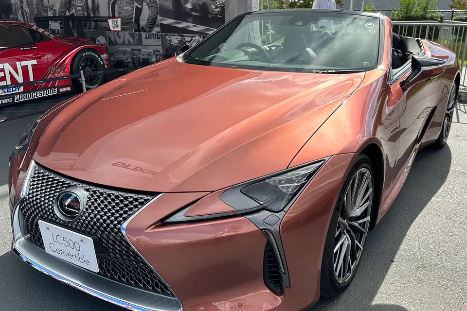 Rose-gold Lexus LC 500 Convertible displayed outdoors, front three-quarter view