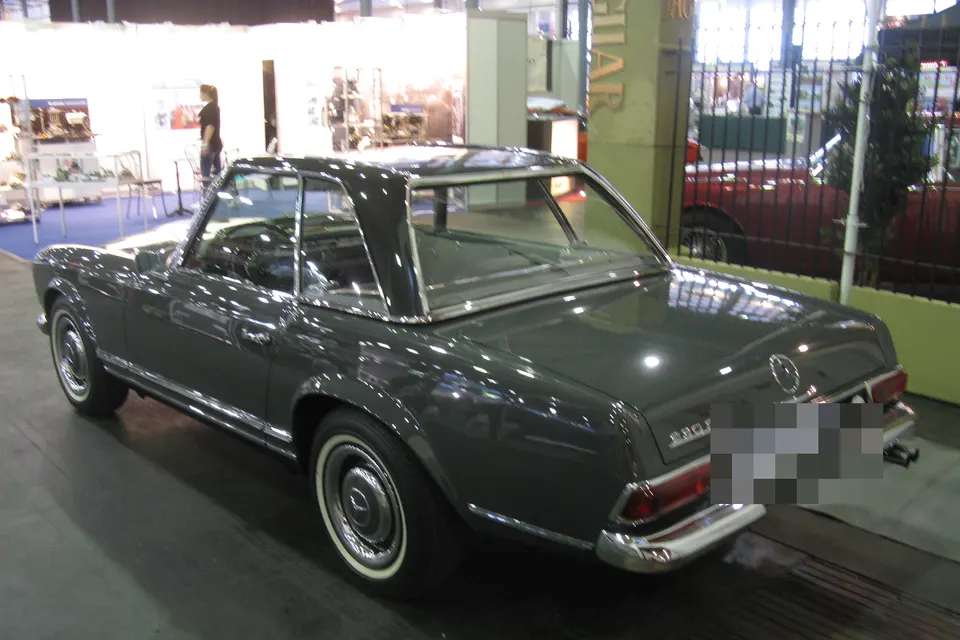 Dark Mercedes-Benz 230 SL W113 with hardtop, rear three-quarter view