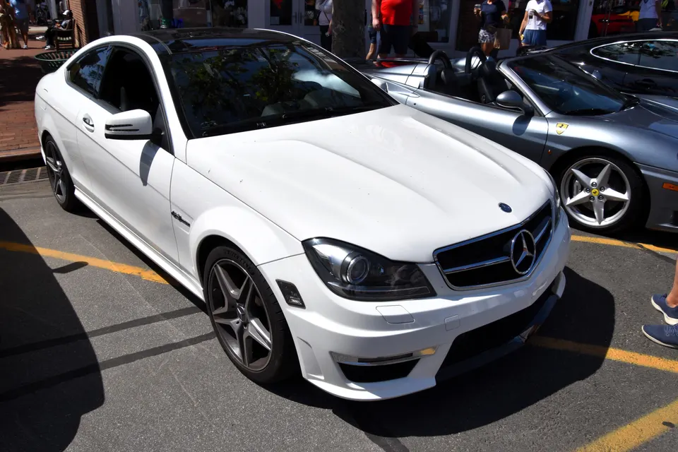 White Mercedes-Benz C 63 AMG Coupé C204, front three-quarter view