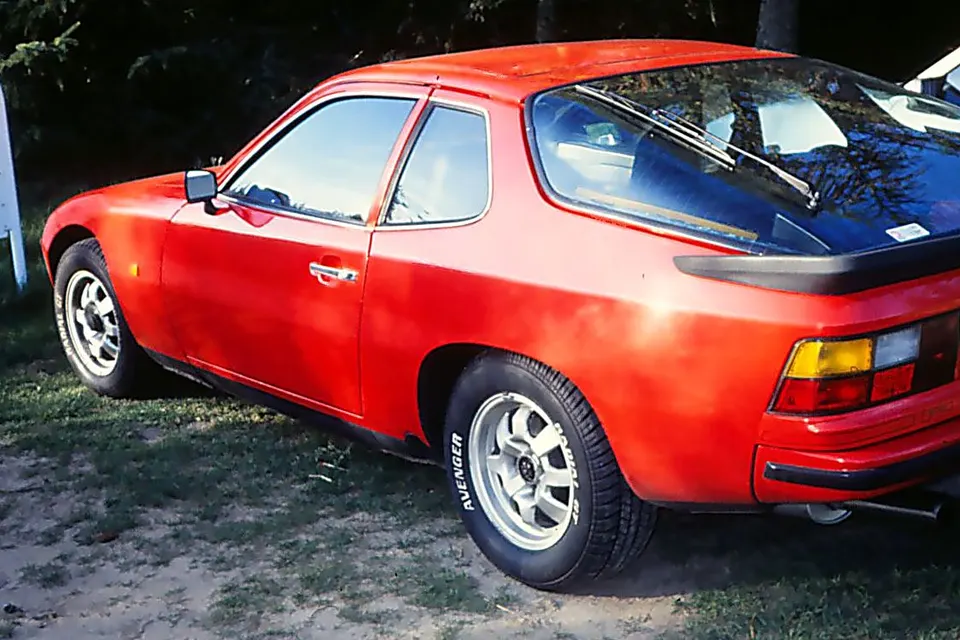 Red early Porsche 924 coupé, rear three-quarter view