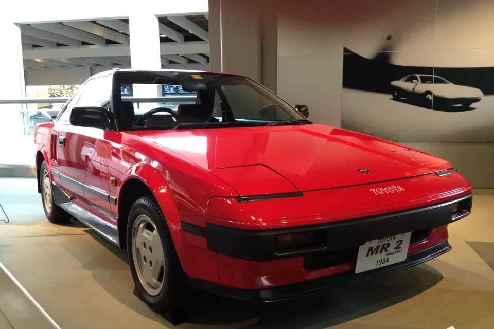 Red first-generation Toyota MR2 AW11 displayed in a museum