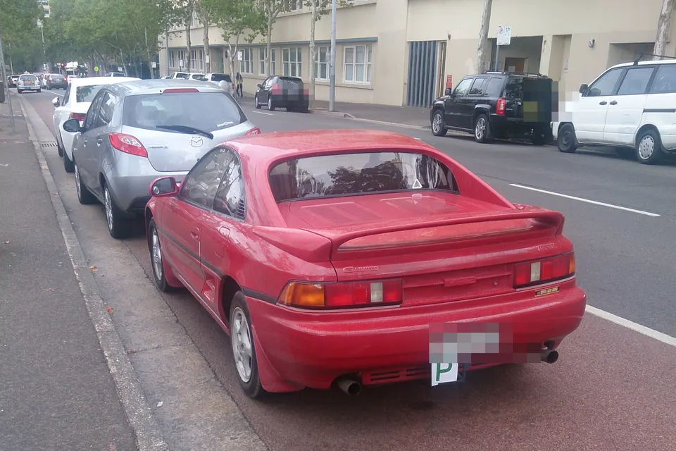 Red second-generation Toyota MR2 SW20 G-Limited coupé, rear three-quarter view