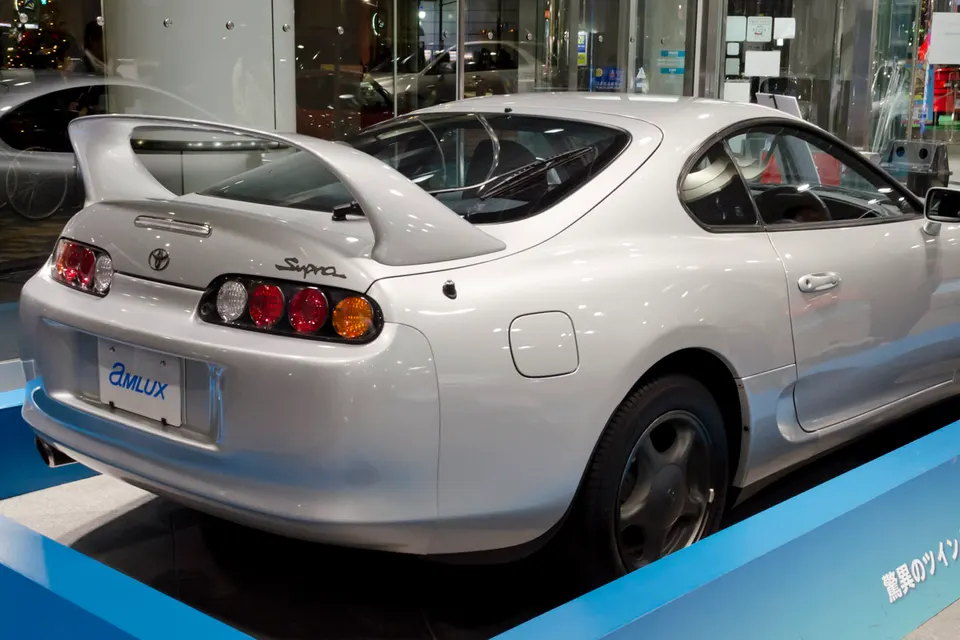 Toyota Supra A80 displayed indoors, rear three-quarter view