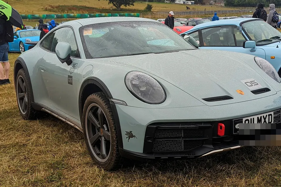 White and blue Porsche 911 Dakar Type 992.1, front three-quarter view