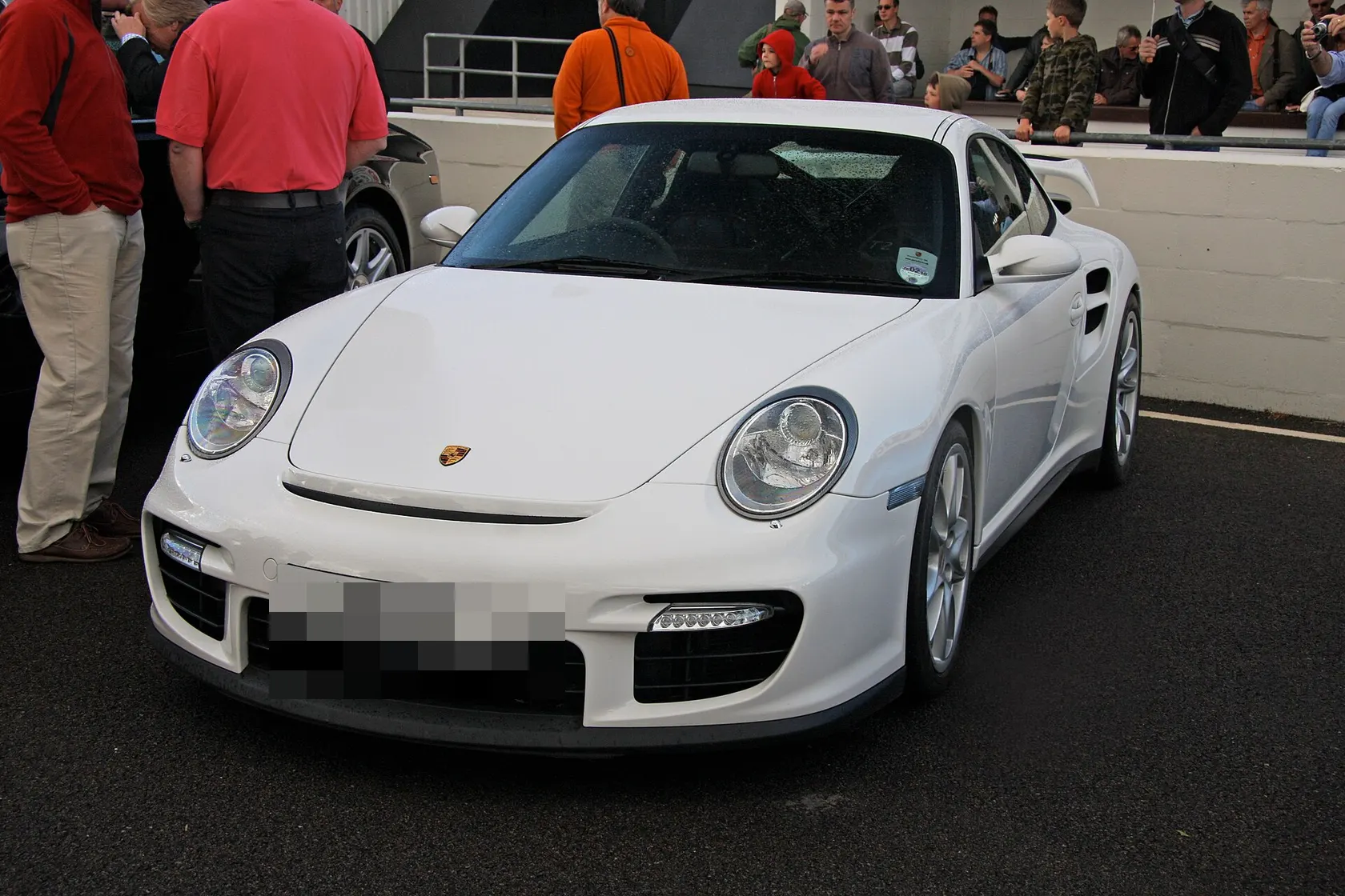 Black Porsche 911 GT2 Type 997.1 on track, front three-quarter view