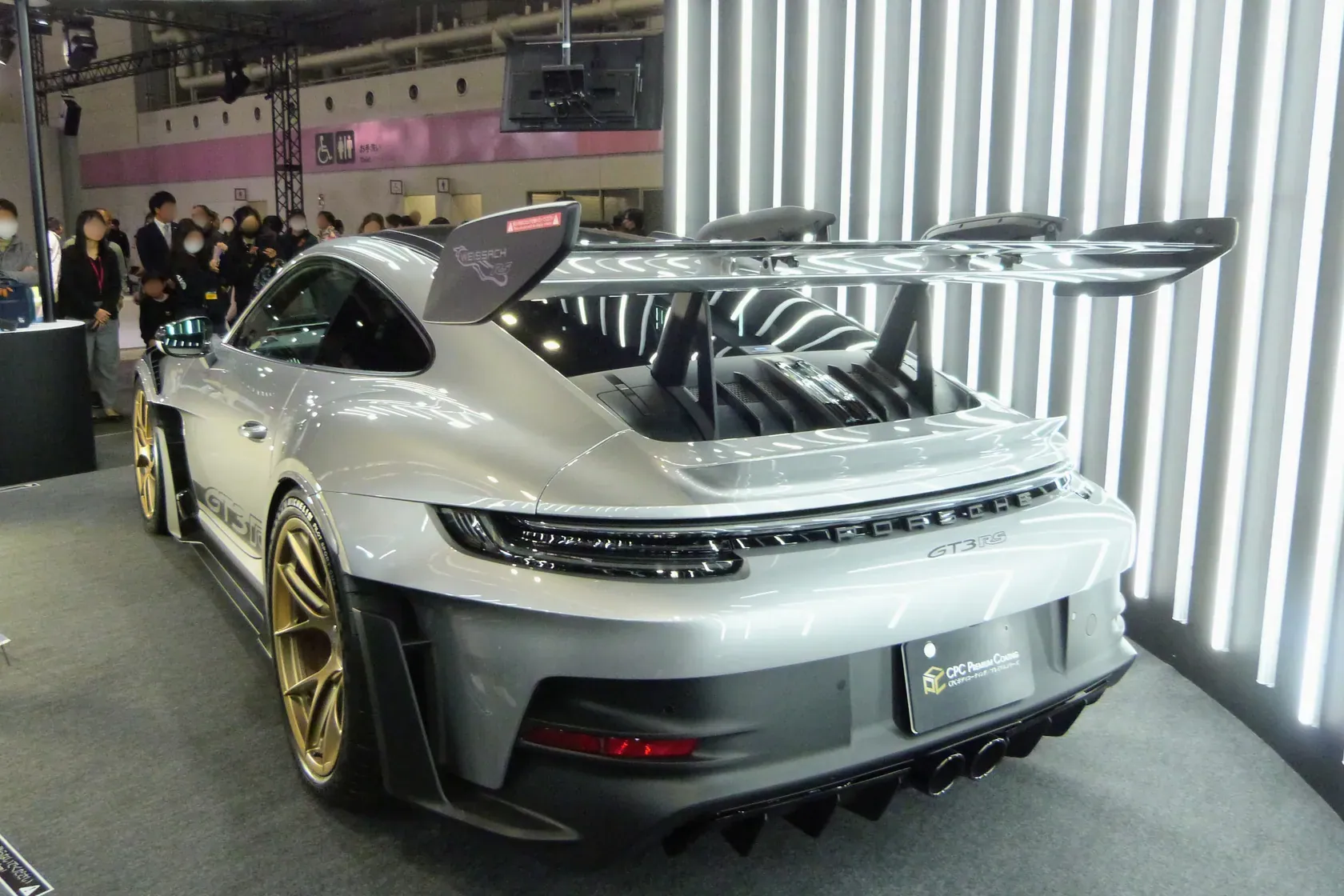 Grey Porsche 911 GT3 RS Type 992.1 photographed from the rear three-quarter angle at Japan Mobility Show Kansai 2025