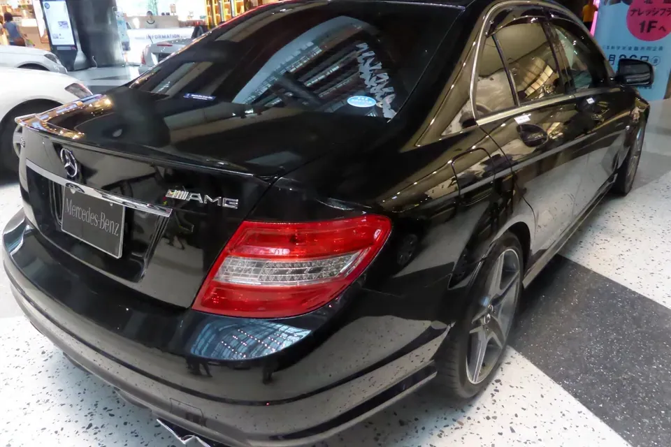 Black Mercedes-Benz C 63 AMG W204 photographed from the rear three-quarter