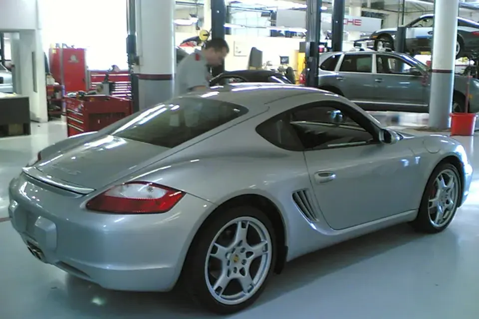 Silver first-generation Porsche Cayman S, front three-quarter view