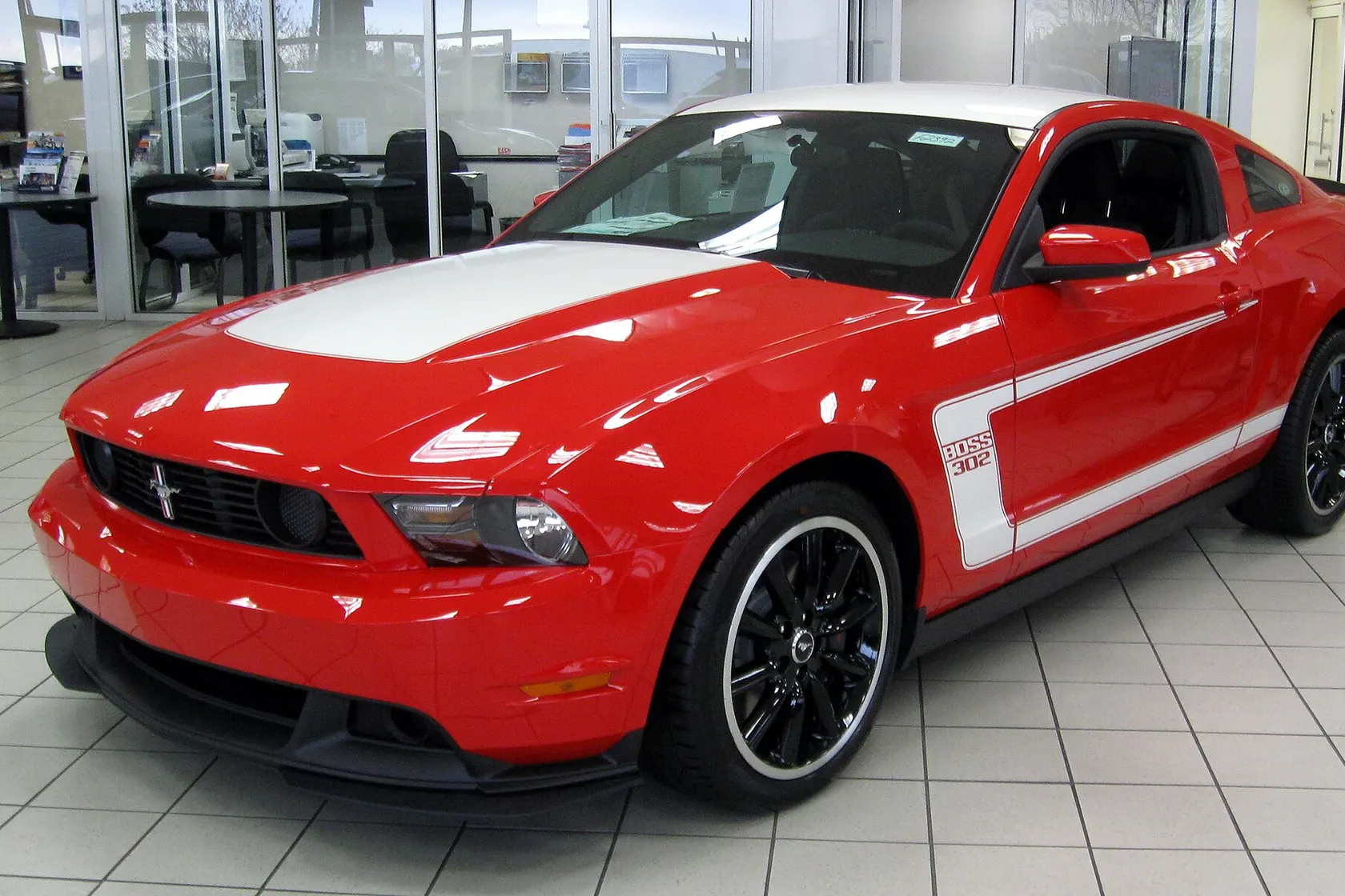 Orange 2012 Ford Mustang Boss 302 in front three-quarter view
