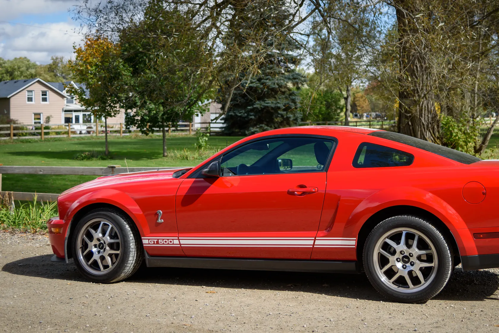 Red 2007 Ford Mustang Shelby GT500 in side profile