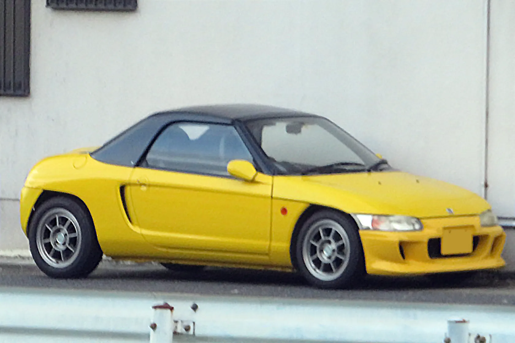 Yellow Honda Beat PP1 in right-side profile