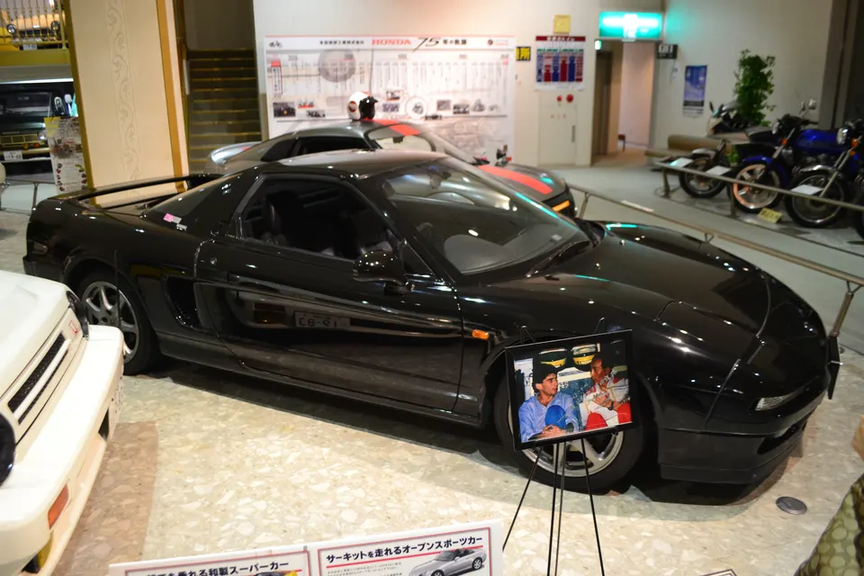 Black Honda NSX NA1 displayed in a motor museum