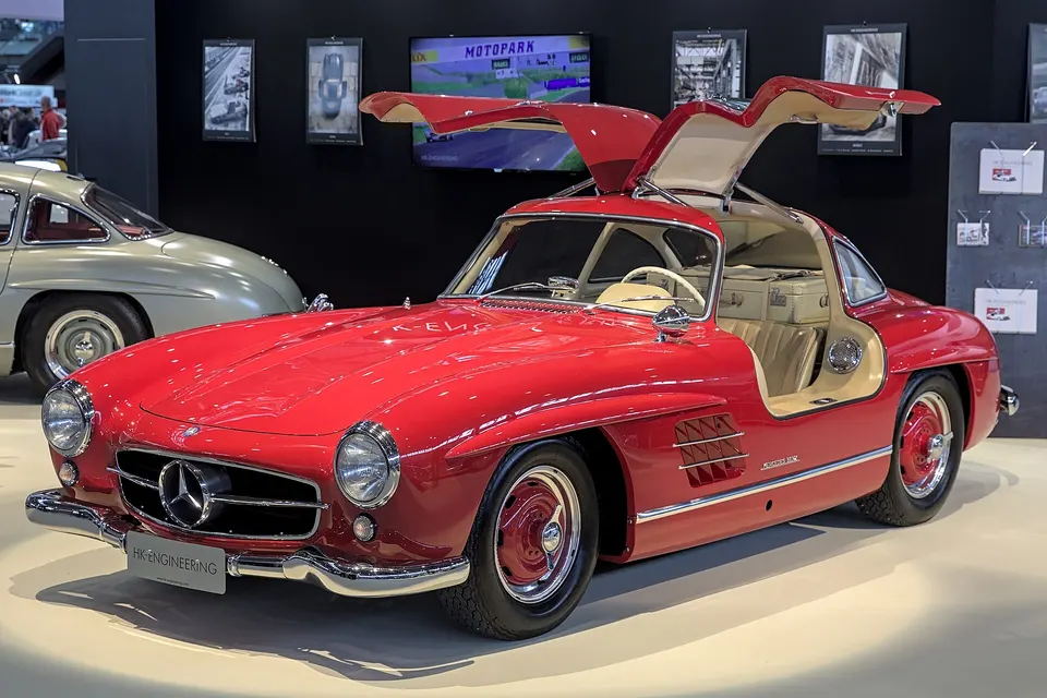 Red Mercedes-Benz 300 SL Gullwing with doors open, front three-quarter view
