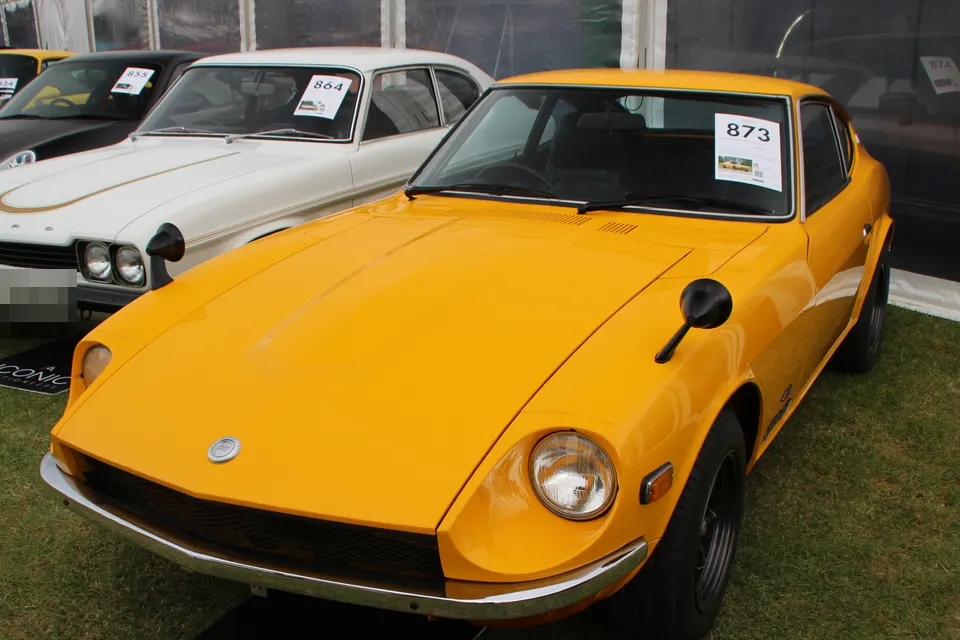 Orange 1970 Fairlady Z432 in front three-quarter view