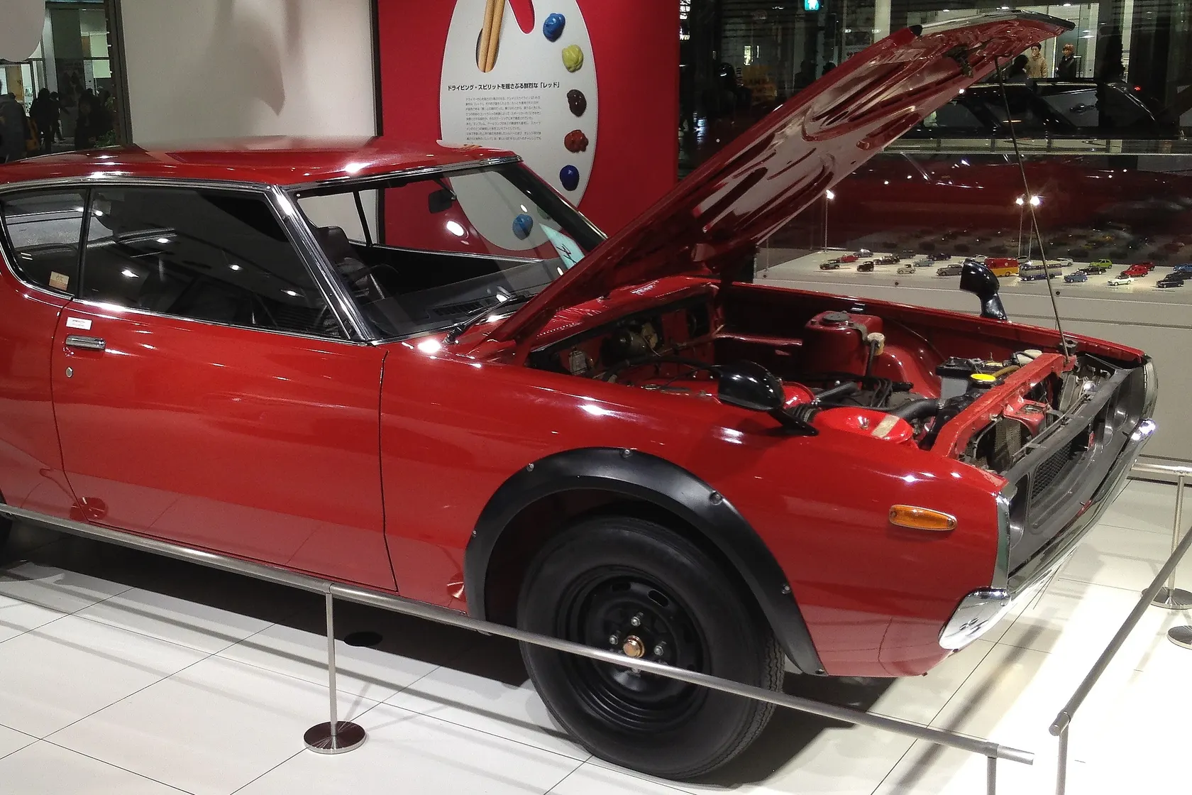 Red Nissan Skyline 2000GT-R KPGC110 displayed with its bonnet open