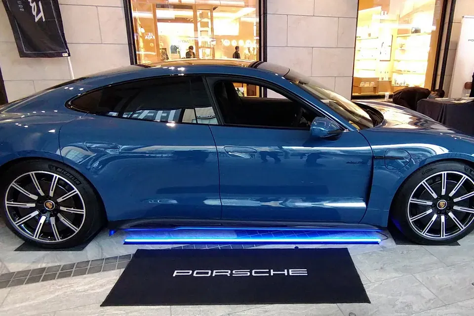 Blue first-generation Porsche Taycan GTS photographed in side profile in Kyoto