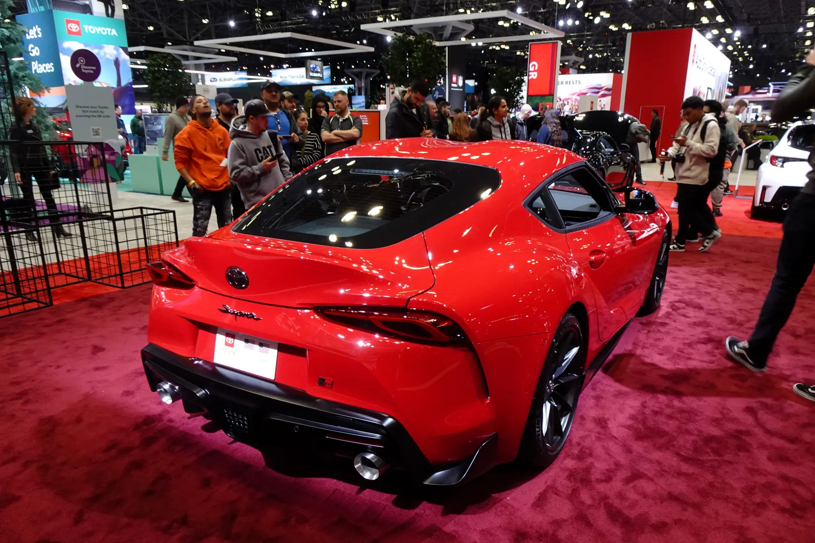 Red Toyota GR Supra 3.0 A90 on display, rear three-quarter view
